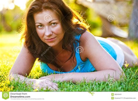 Brunette Girl Lying On The Grass Stock Image Image Of Green Eyes