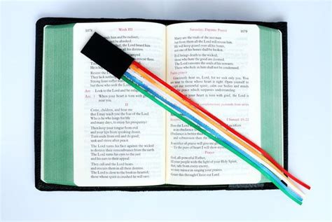 An Open Book With Two Colored Pencils Sticking Out Of It