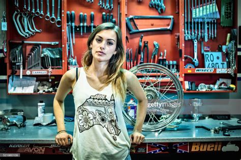 Portrait Of Young Female Mechanic In Motorcycle Workshop Woman