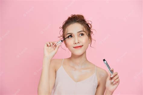Premium Photo Young Beautiful Asian Woman Applying Black Mascara On