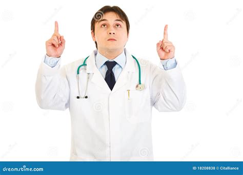 Smiling Young Medical Doctor Pointing Fingers Up Royalty Free Stock