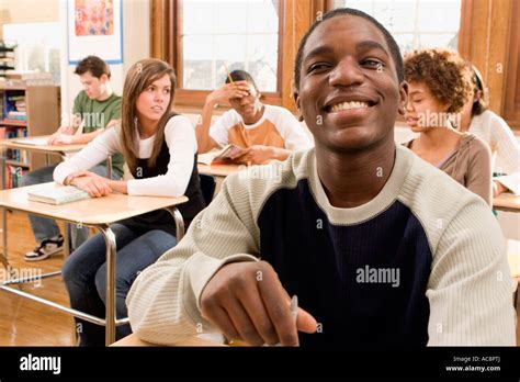 Students Sitting At Desks In A Classroom Stock Photo Alamy