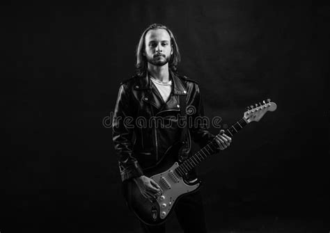 Bearded Rock Musician Playing Electric Guitar In Leather Jacket