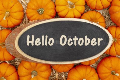 Hello October Message On A Wood Chalkboard Sign On Pumpkins Stock Image