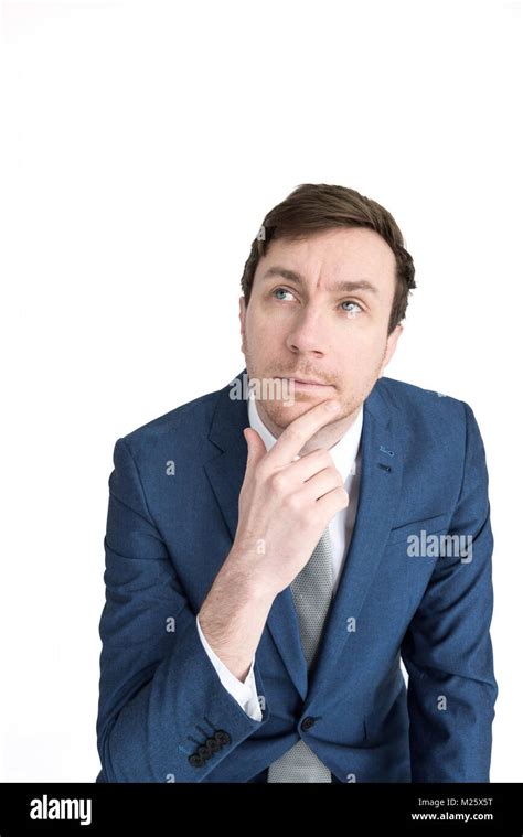 Portrait Of A Smartly Dressed Man With His Hand On His Chin Like He Is Thinking Or Contemplating
