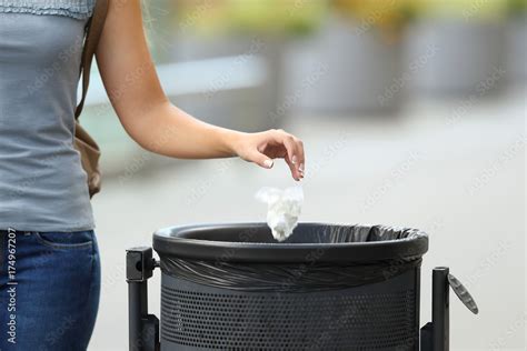 Civic Woman Throwing Garbage In A Trash Bin Stock Photo Adobe Stock
