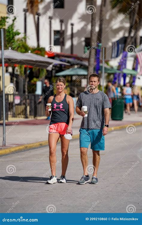 Street Photography Couple Walking And Holding Starbucks Coffee In Hands