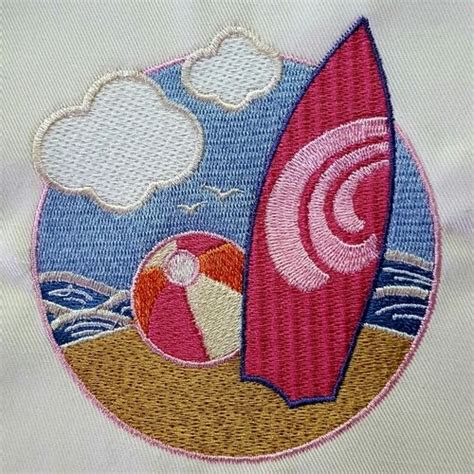 An Embroidered Patch With A Beach Ball And Surfboard In The Sand On A