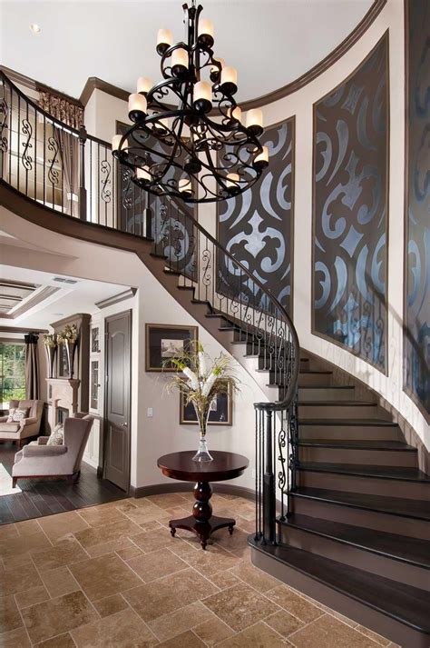 You find information on curved staircases costs, helical stairs plans and curved stairways ideas the railing has curved handrail, turned spindles and handcrafted extraordinary newel posts at staircase entrance. Verona Foyer | House design, House entrance, Staircase design