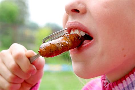 Children Eating Sausage Stock Photos Pictures And Royalty Free Images