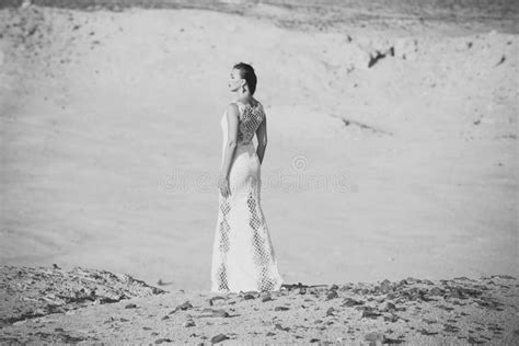 Wedding Agency Woman In White Dress Standing On Sand Dunes In Desert