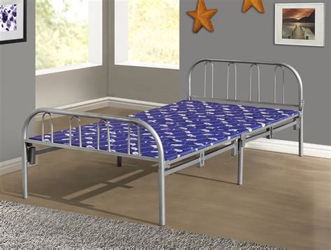 A Metal Bed Frame With Blue Sheets And Stars On The Wall Above It In A