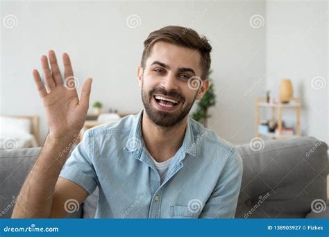 Friendly Happy Man Waving Hand Saying Hello Looking At Camera Stock