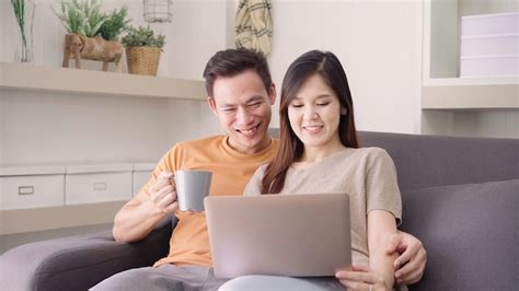 Free Photo Asian Couple Using Laptop And Drinking Warm Cup Of Coffee