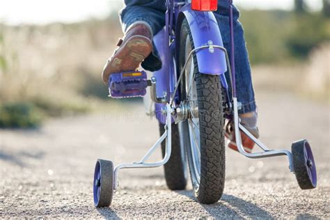 Learning To Ride A Bike With Training Wheels Stock Image Image Of
