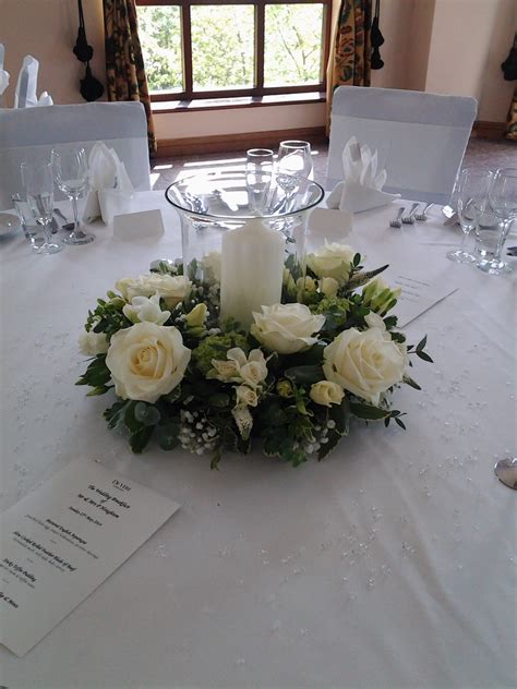 Wedding Reception Table Decoration Made Using Fresh Flowers And Fol