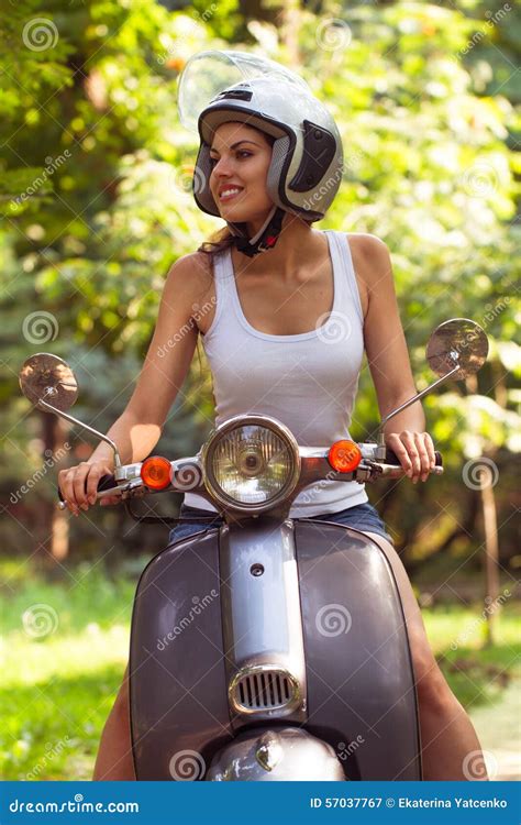 Young And Beautiful Woman On A Scooter On The Street And Smiling Stock Image Image Of