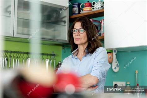 Portrait Of Pensive Mature Woman In Kitchen At Home — Indoors Ser