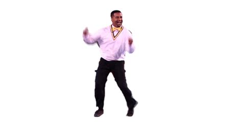 A Man In A White Shirt And Black Pants Is Jumping Into The Air With His