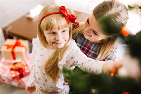Free Photo Daughter Kissing Mother At Christmas