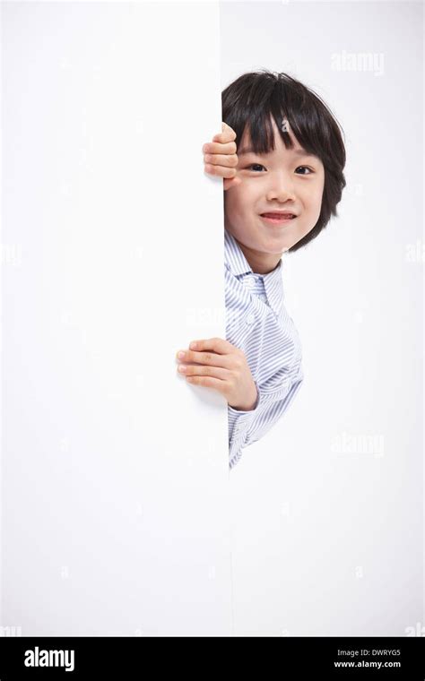 A Kid Hiding Behind A White Wall Stock Photo Alamy