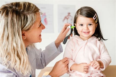 Otolaryngologist Checking Up On A Sweet Little Girl Premium Image By