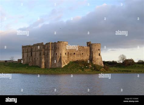 Carew Castle And Mill At Sunset In Carew Pembrokeshire Uk Credit