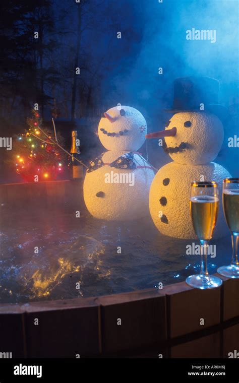 Two Snowpeople Sitting In A Hot Tub Celebrating Holidays Stock Photo