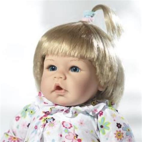 A Baby Doll With Blonde Hair And Blue Eyes