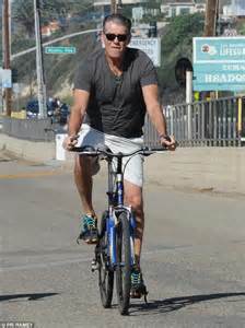 Pierce Brosnan Sticks Out His Tongue While On Romantic Bike Ride With