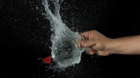 Water Balloon Bursting Slow Motion Hd By Drawing Pin Held By Hand In