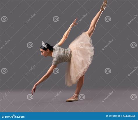 Ballerina Bending Down And Raising One Leg Up In Studio Stock Photo