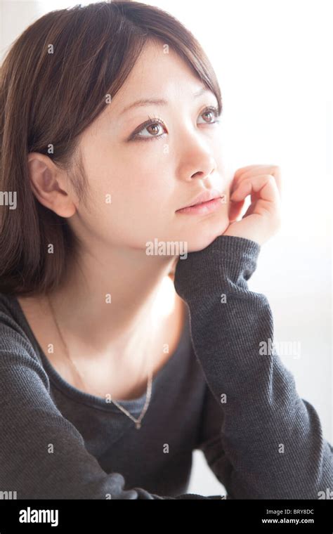 Young Woman Resting Her Chin In Her Hand Stock Photo Alamy