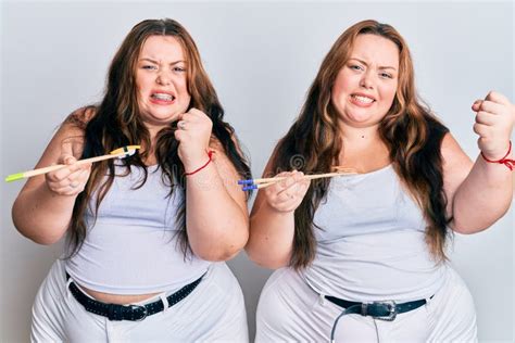 Plus Size Caucasian Sisters Woman Eating Eel Sushi Using Chopsticks