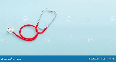 Red Stethoscope On Blue Color Background Concept Of Medicine And