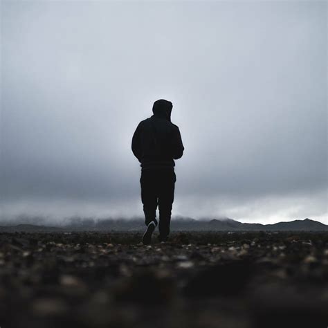 Man Walking Pebbles Mountain Distance Silhouette Standing