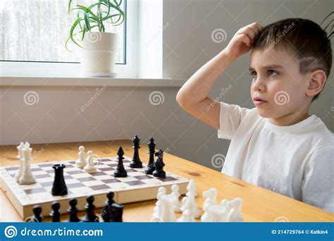 A Preschool Boy Ponders His Move In A Chess Game Board Game Stock