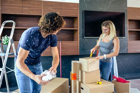 Couple Unpacking Moving Boxes Stock Photo Containing Couple And