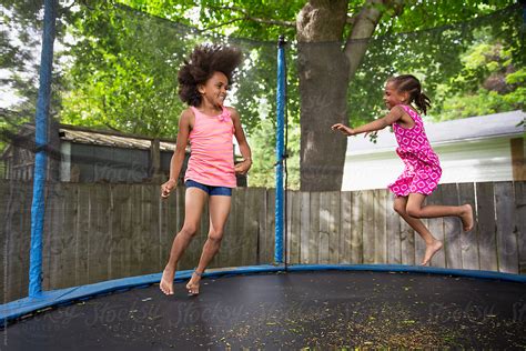 Pair Of Girls Jumping On A Trampoline By Stocksy Contributor Anya