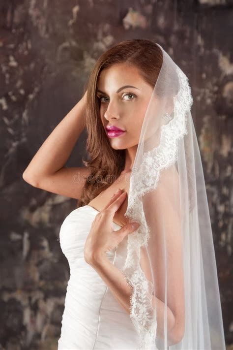 Beautiful Bride In A Wedding Dress With Bare Shoulders And Veil Stock