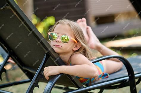 Free Photo Sunbathing Cute Little Blonde Girl In Sunglasses Sunbathing