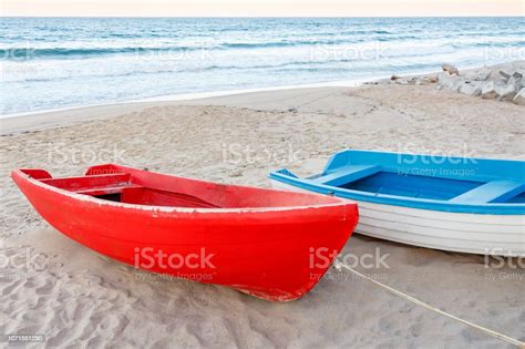 Old Red And White Blue Boats On The Beach Waves On The Water Sky
