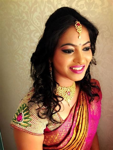 traditional southern indian bride wearing bridal hair saree and jewellery reception look