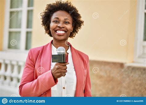 Young African American Woman Journalist Holding Reporter Microphone