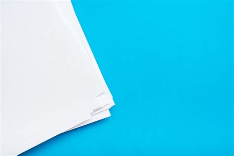 Premium Photo A Stack Of Clean White Paper On A Table On A Blue