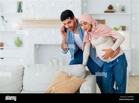 Worried Arab Husband Calling Doctor Or Ambulance While His Pregnant Wife Having Prenatal