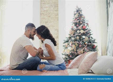 Happy Couple Of Lovers Sitting On The Bed Christmas Interior Lovers