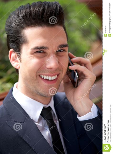 Happy Young Businessman Talking On The Phone Outdoors Stock Image