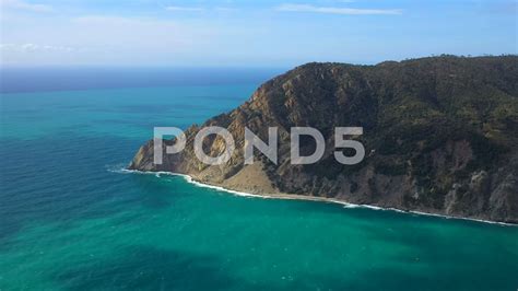 The Calm Deep Ocean In Cinque Terre Italy Surrounding The High Cliffs