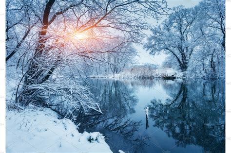 Winter Forest On The River At Sunset Colorful Landscape With Snowy